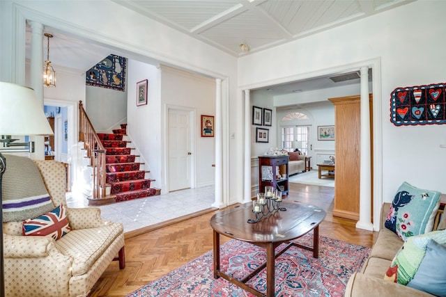 living area with baseboards, stairway, and a notable chandelier