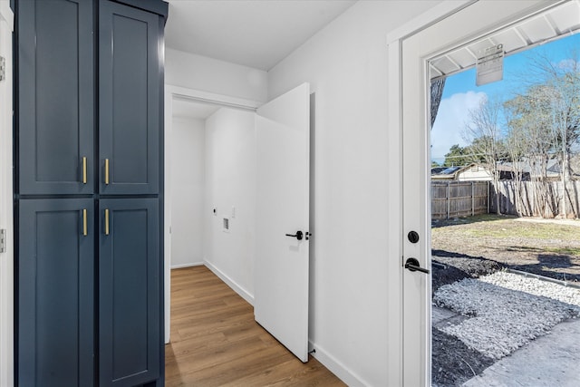 corridor with wood finished floors and baseboards