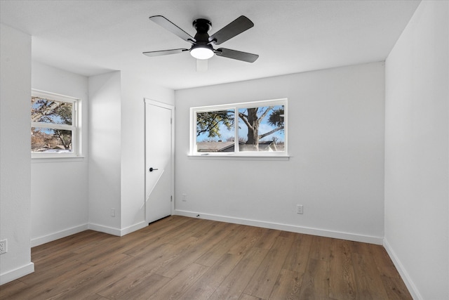 unfurnished bedroom featuring a ceiling fan, baseboards, and wood finished floors