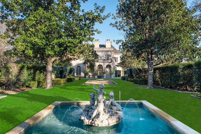 exterior space with a chimney and a lawn