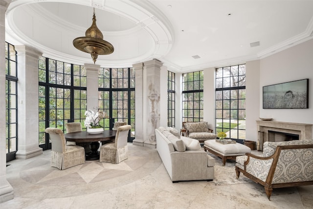 sunroom featuring a fireplace and ornate columns