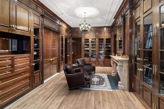 interior space with light wood-style floors, an inviting chandelier, and crown molding