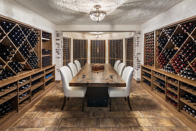 wine room featuring stone finish flooring and a textured ceiling