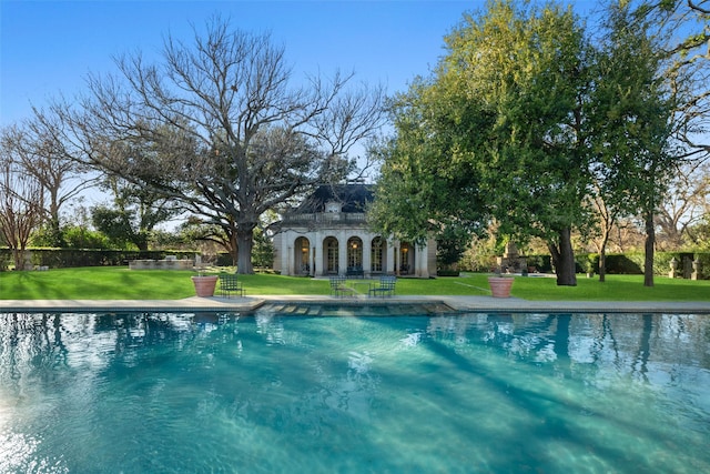 view of pool featuring an outdoor structure, a storage structure, and a lawn