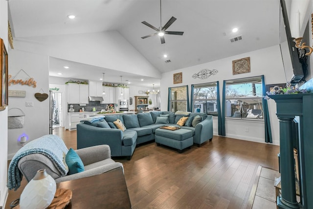 living room with visible vents, wood finished floors, ceiling fan with notable chandelier, high vaulted ceiling, and recessed lighting