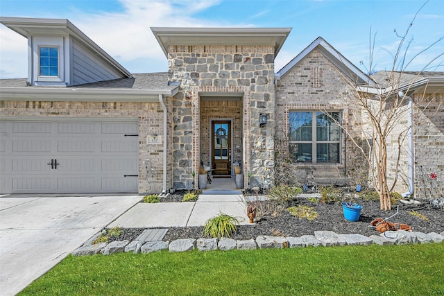 view of front of property with a garage, brick siding, a shingled roof, stone siding, and driveway