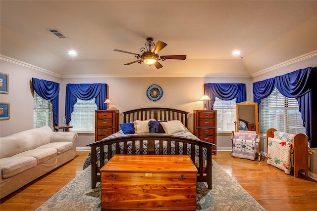 bedroom with a ceiling fan, baseboards, visible vents, light wood-style floors, and crown molding