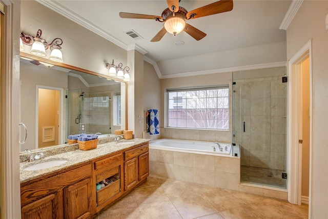 bathroom with a stall shower, ornamental molding, a garden tub, and a sink