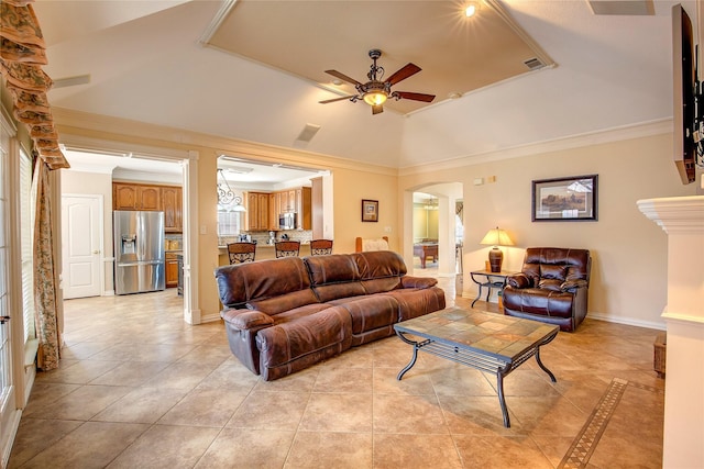 living room with arched walkways, a raised ceiling, crown molding, and ceiling fan