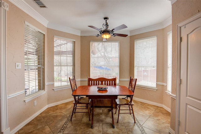 dining space with ceiling fan, a textured wall, visible vents, baseboards, and ornamental molding