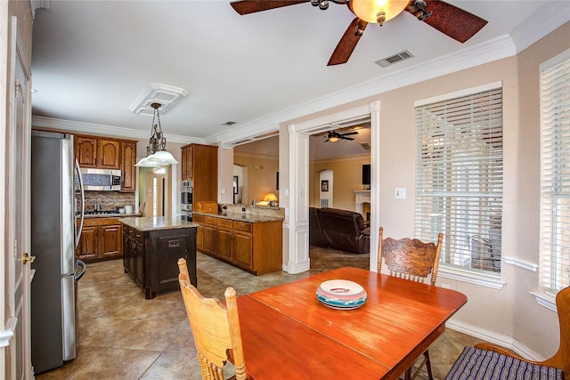 dining space with baseboards, visible vents, ceiling fan, crown molding, and light tile patterned flooring