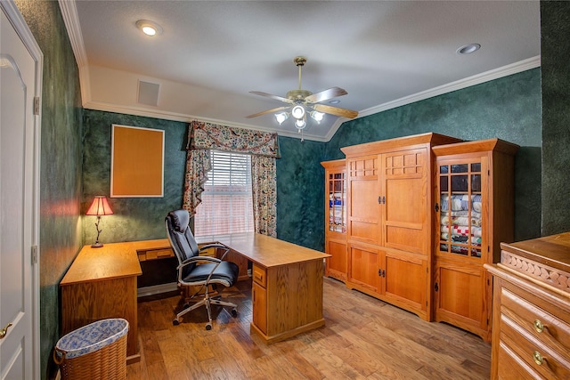 office space featuring wallpapered walls, ornamental molding, light wood-style flooring, and a ceiling fan