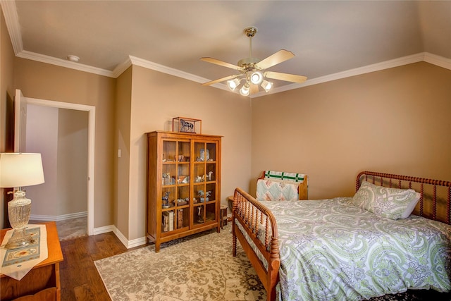 bedroom with ornamental molding, dark wood-type flooring, a ceiling fan, and baseboards