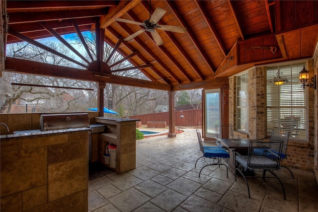 unfurnished sunroom with lofted ceiling with beams, ceiling fan, and wooden ceiling