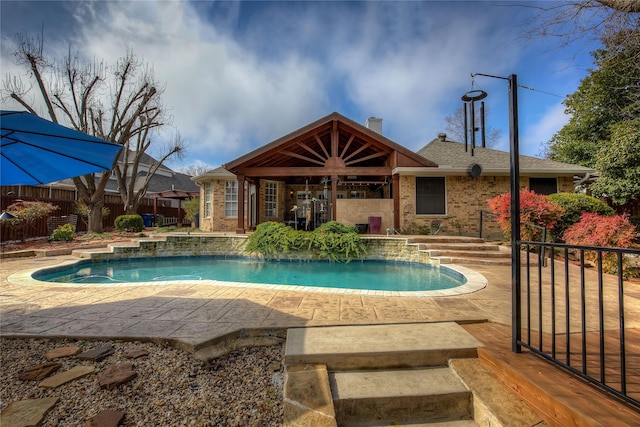 outdoor pool featuring a patio area and fence