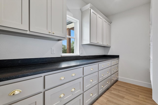 interior details featuring wood finished floors and baseboards