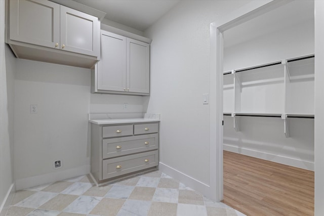 walk in closet with light floors