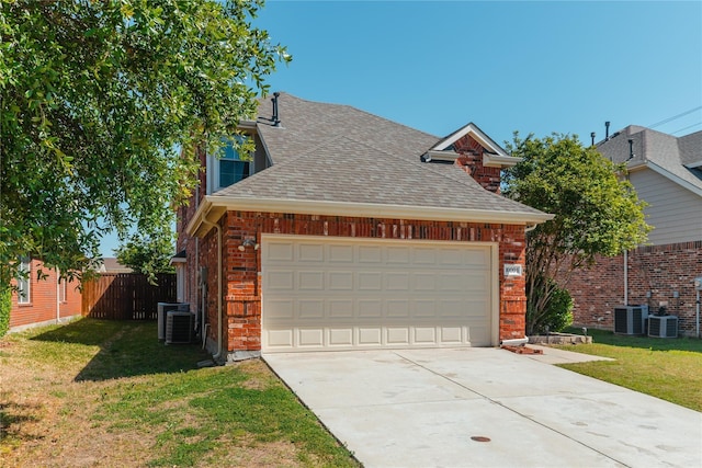 exterior space with a shingled roof, central AC unit, concrete driveway, a front lawn, and brick siding