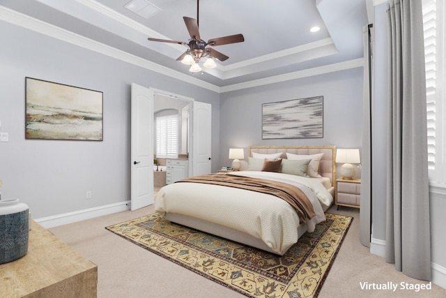 bedroom featuring a tray ceiling, light colored carpet, visible vents, ornamental molding, and baseboards