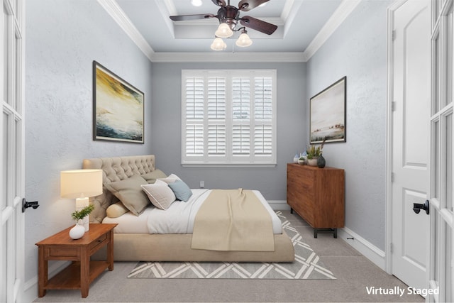 carpeted bedroom featuring baseboards, a tray ceiling, crown molding, and a textured wall