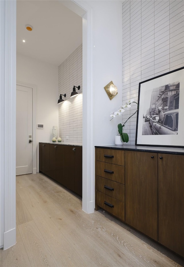 bathroom featuring wood finished floors, vanity, and baseboards