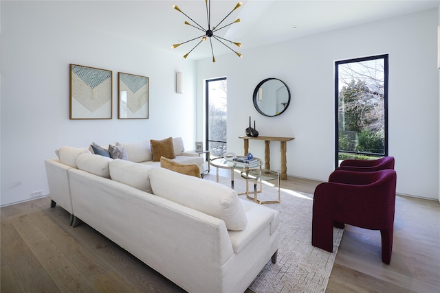 living room featuring a chandelier and wood finished floors