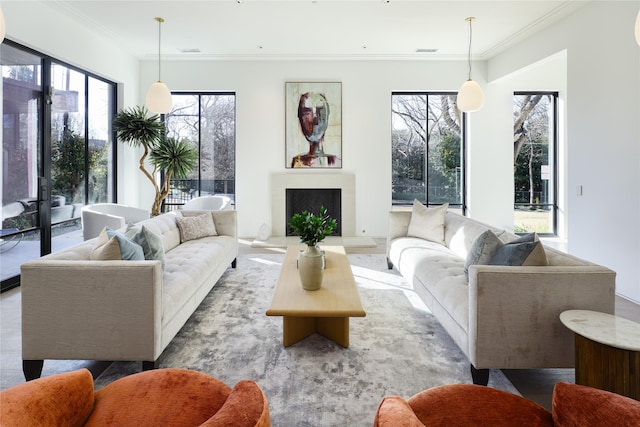 living area with a fireplace with raised hearth, visible vents, and crown molding