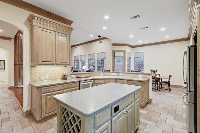 kitchen featuring arched walkways, stainless steel appliances, visible vents, and a center island