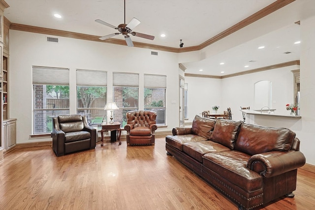 living area featuring ornamental molding, visible vents, and light wood-style floors