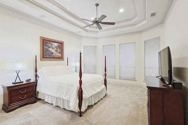 bedroom featuring crown molding, a raised ceiling, visible vents, light carpet, and ceiling fan