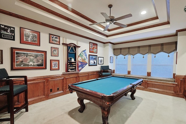 playroom with billiards, a raised ceiling, light colored carpet, a wainscoted wall, and crown molding