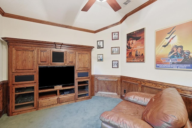 living area featuring a wainscoted wall, crown molding, and light colored carpet