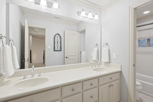 bathroom with ornamental molding, a sink, and visible vents