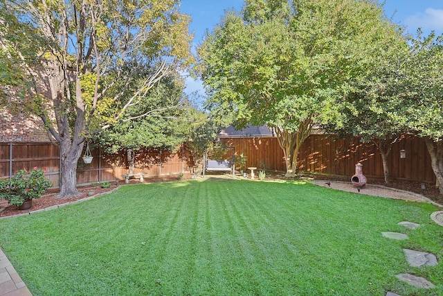 view of yard with a fenced backyard