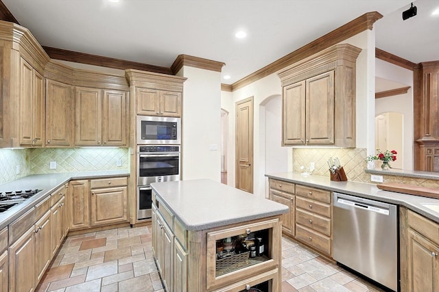 kitchen with tasteful backsplash, stone tile flooring, light countertops, light brown cabinetry, and appliances with stainless steel finishes