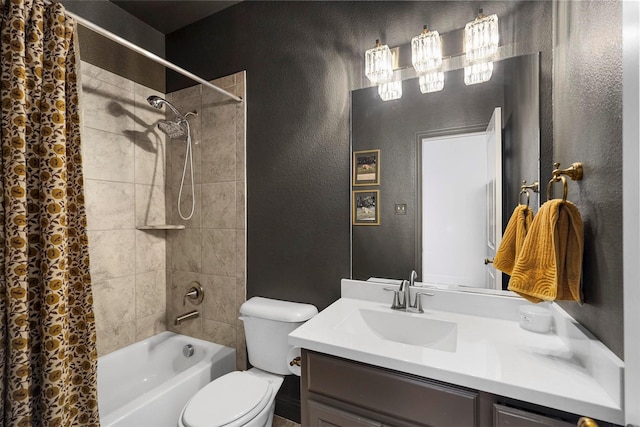 bathroom with toilet, a textured wall, shower / tub combo, and vanity