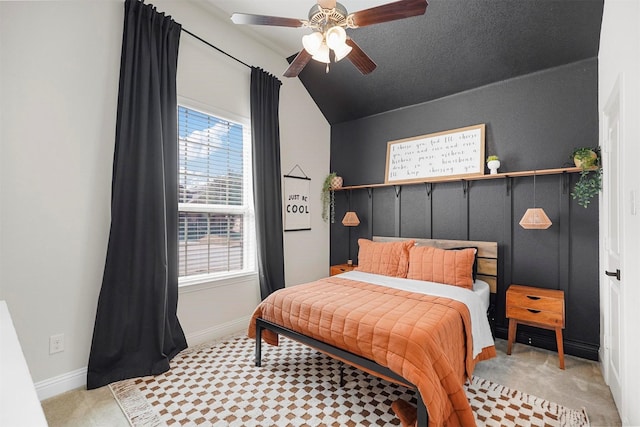 bedroom featuring a ceiling fan, lofted ceiling, light carpet, and baseboards