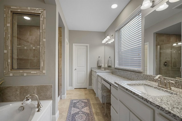 bathroom featuring a garden tub, visible vents, vanity, baseboards, and a stall shower