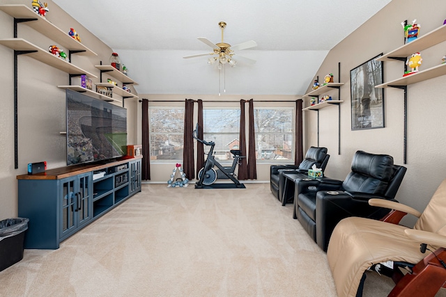 living area featuring vaulted ceiling, a ceiling fan, and light colored carpet