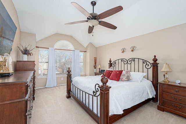 bedroom featuring lofted ceiling, a ceiling fan, and light colored carpet