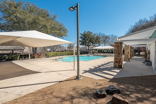 pool featuring a patio area and fence