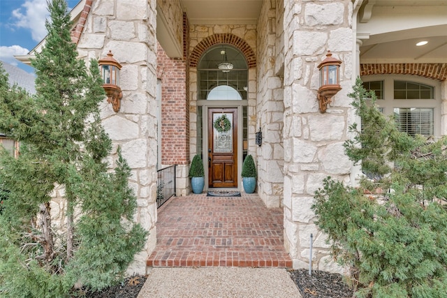 property entrance featuring stone siding and brick siding