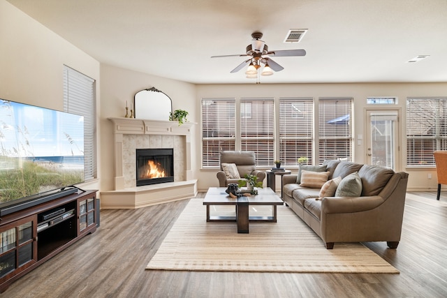 living area featuring plenty of natural light, visible vents, and wood finished floors