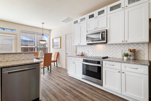 kitchen featuring appliances with stainless steel finishes, dark wood-style flooring, visible vents, and white cabinetry