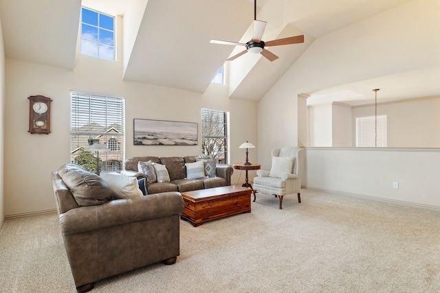 carpeted living room featuring high vaulted ceiling, plenty of natural light, baseboards, and ceiling fan