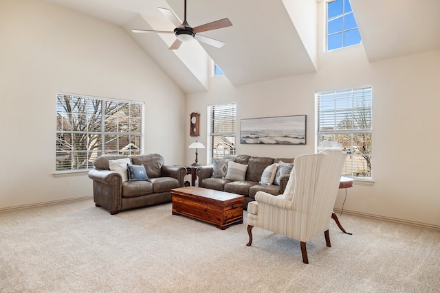 carpeted living room with high vaulted ceiling, ceiling fan, and baseboards