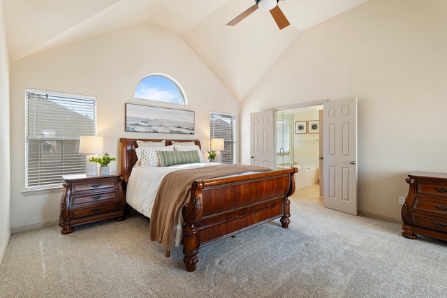 bedroom featuring baseboards, a ceiling fan, ensuite bath, carpet, and high vaulted ceiling