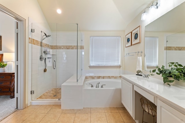 bathroom with a garden tub, lofted ceiling, a sink, a shower stall, and tile patterned flooring