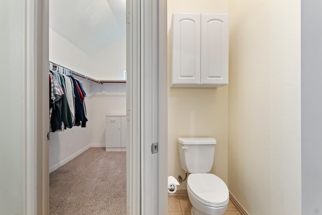 bathroom with toilet, baseboards, and vaulted ceiling