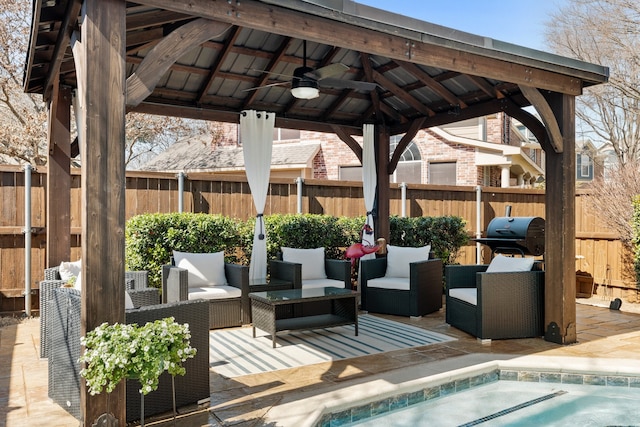 view of patio / terrace featuring fence, grilling area, a gazebo, and ceiling fan